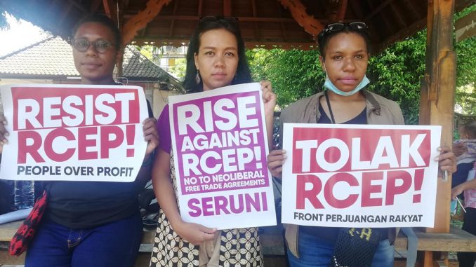 Feminist protesters holding placards to resist and rise against the Regional Comprehensive Economic Partnership.