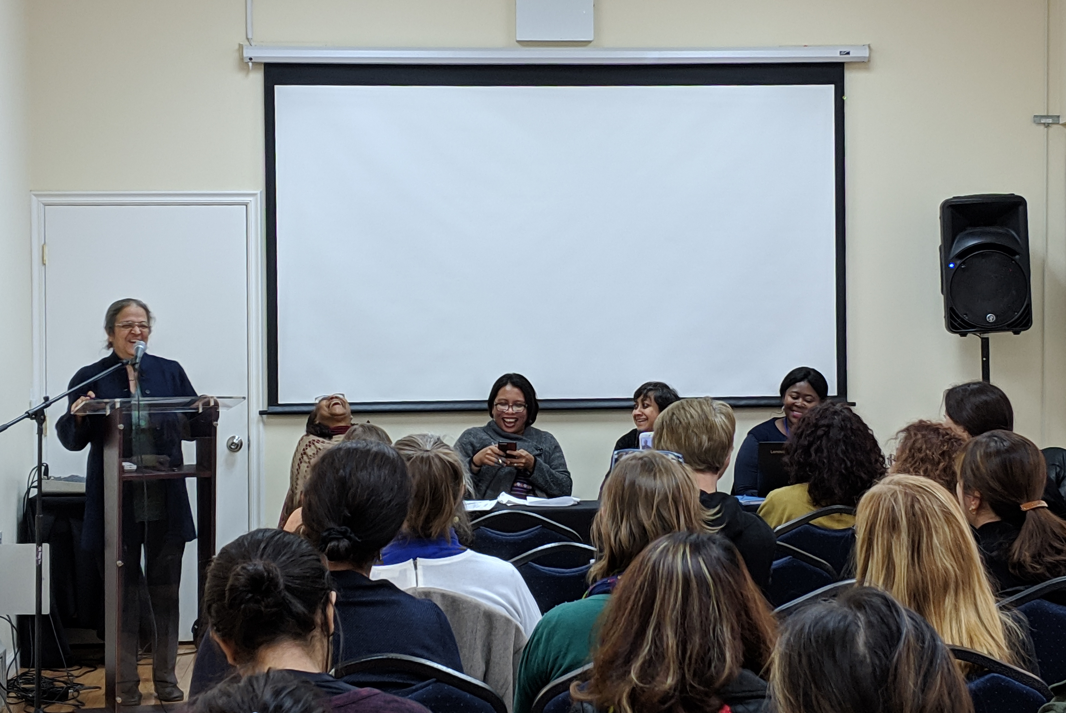 Panelists from global South feminist groups laughing at the launch of the Gender and Trade Coalition in 2019.